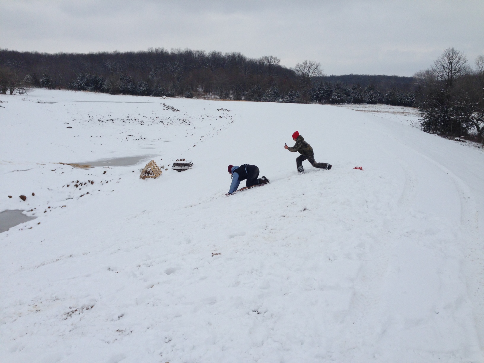 Attached picture pond w wife and kids sledding.JPG